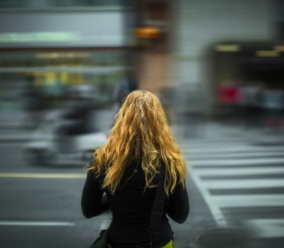 Conversation Topics - a woman crossing a busy road