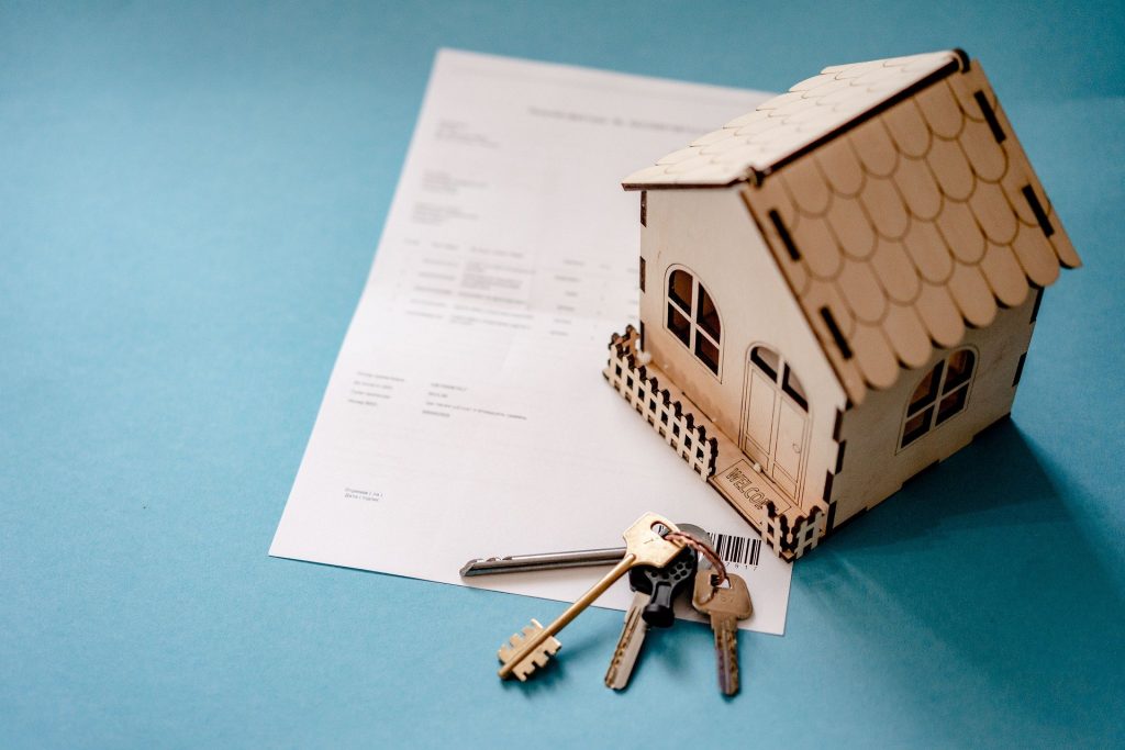 The property market, a photo of a house model with keys to depict this ielts writing task.
